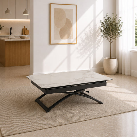 Tavolo trasformabile Crono con piano effetto marmo Carrara, angoli arrotondati e struttura in metallo antracite. Dotato di meccanismo regolabile in altezza e sistema allungabile, si trasforma facilmente da tavolino da salotto a tavolo da pranzo per ottimizzare gli spazi.